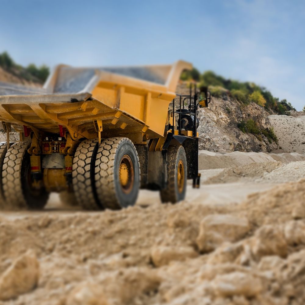 Big yellow quarry truck in a stone through mounds 2025 01 09 12 23 00 utc